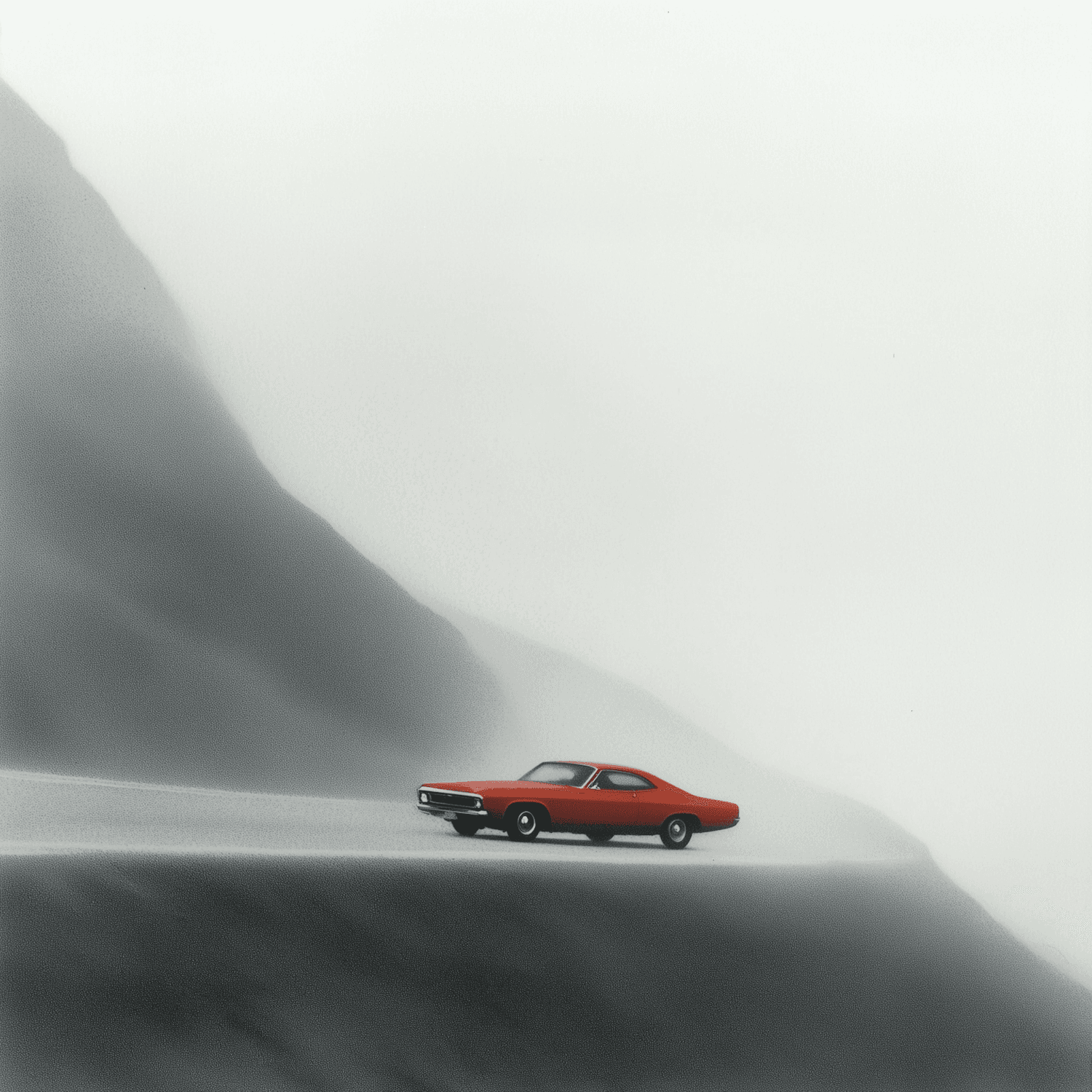 A red classic car on a misty mountain road